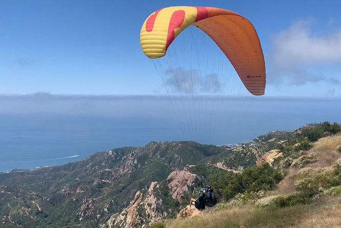 Tandem Paragliding flight with instructor in Malibu - Harnessing up: how the tandem flight is set up for comfort